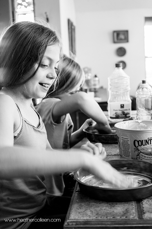 Little girls buttering baking pans Gilmer Tx